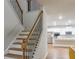Traditional staircase with wood treads and wrought iron spindles leads to the kitchen at 3004 Amabile Rd, Dacula, GA 30019