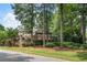 Brick home nestled among lush trees and landscaping at 1446 W Wesley Nw Rd, Atlanta, GA 30327