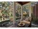 Screened porch overlooks the backyard and features comfortable seating at 1446 W Wesley Nw Rd, Atlanta, GA 30327