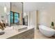 Modern bathroom with a floating vanity, free-standing tub, and a large window at 1500 W Wesley Nw Rd, Atlanta, GA 30327