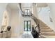 Elegant entryway with curved staircase and high ceilings at 1500 W Wesley Nw Rd, Atlanta, GA 30327