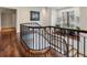 Upper hallway with hardwood floors and a window overlooking the backyard at 1500 W Wesley Nw Rd, Atlanta, GA 30327