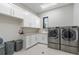 Laundry room with washer, dryer, and ample counter space at 1500 W Wesley Nw Rd, Atlanta, GA 30327