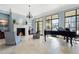 Light-filled living room with fireplace and grand piano at 1500 W Wesley Nw Rd, Atlanta, GA 30327