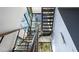 Contemporary staircase with metal railing and large windows, filling the space with light at 1500 W Wesley Nw Rd, Atlanta, GA 30327