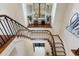 Impressive curved staircase with metal railing and hardwood steps at 1500 W Wesley Nw Rd, Atlanta, GA 30327