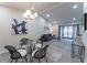 Bright dining area with glass table and four chairs, an area rug, and a modern chandelier at 2125 Jessica Way, Lithonia, GA 30058