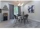 Dining area with glass table, four chairs, and a modern chandelier at 2125 Jessica Way, Lithonia, GA 30058