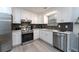 Modern kitchen with white cabinets, stainless steel appliances, and herringbone backsplash at 2125 Jessica Way, Lithonia, GA 30058