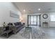 Living room with hardwood floors, gray sofa, and a bay window at 2125 Jessica Way, Lithonia, GA 30058