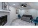 Living room with fireplace, gray couch, and teal accent chairs at 2125 Jessica Way, Lithonia, GA 30058