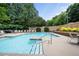 Beautiful community pool with lounge area and lush landscaping creating a resort-like atmosphere at 234 Ashford Cir, Atlanta, GA 30338