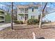 Two-story light green house with a front porch and driveway at 283 Boulder Park Ln, Atlanta, GA 30331