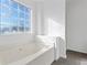 Bathroom featuring a soaking tub and a large window at 5728 Rock Shoals Way, Atlanta, GA 30349