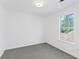 This bright bedroom features a neutral color palette and a window view at 5728 Rock Shoals Way, Atlanta, GA 30349