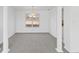 Empty dining room features decorative pillars, gray carpet, light fixture and ample natural light at 5728 Rock Shoals Way, Atlanta, GA 30349