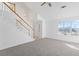 Living room with vaulted ceiling, fan, stairs with white railing and ample sunlight at 5728 Rock Shoals Way, Atlanta, GA 30349