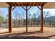 Spacious backyard with a wooden deck and privacy fence, offering a tranquil view of the surrounding landscape at 210 Idylwilde Way, Canton, GA 30115