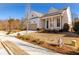 White craftsman style home with a taupe garage and landscaped yard at 210 Idylwilde Way, Canton, GA 30115