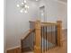 Elegant staircase with oak railing and black balusters at 210 Idylwilde Way, Canton, GA 30115