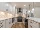 Modern kitchen with white cabinets, quartz countertops and black appliances at 2911 Bentwood Dr, Marietta, GA 30062