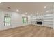 Bright living room featuring hardwood floors, fireplace, built-in shelves, and French doors at 2911 Bentwood Dr, Marietta, GA 30062