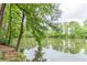 Serene pond view with lush green trees and reflections at 2911 Bentwood Dr, Marietta, GA 30062