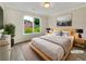 Cozy bedroom showcasing natural light from the window, complemented by warm, neutral tones at 3714 Thunder Ne Way, Marietta, GA 30066