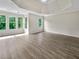 Large bedroom boasts wood floors, tray ceilings, recessed lights, and multiple windows with scenic views at 3714 Thunder Ne Way, Marietta, GA 30066