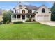 Charming two-story brick home featuring a welcoming front porch and a well-manicured lawn at 3714 Thunder Ne Way, Marietta, GA 30066