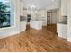 New kitchen boasts an island, white cabinets, stainless appliances, and gorgeous hardwood floors at 3714 Thunder Ne Way, Marietta, GA 30066