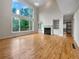 Bright living room featuring hardwood floors, large windows, and a fireplace, perfect for entertaining at 3714 Thunder Ne Way, Marietta, GA 30066