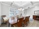 Bright dining room features a large table, hardwood floors, and a chandelier at 7350 Rambling Vale, Cumming, GA 30028