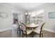 Bright dining room with round table and six chairs, hardwood floors and fireplace view at 7350 Rambling Vale, Cumming, GA 30028