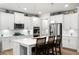 Modern kitchen with island, stainless steel appliances, and hardwood floors at 7350 Rambling Vale, Cumming, GA 30028