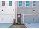 Townhouse exterior with gray and white brick, attached garages, and landscaping at 147 Bluffington Way, Marietta, GA 30066