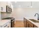 Modern kitchen with white cabinets, stainless steel appliances, and quartz countertops at 147 Bluffington Way, Marietta, GA 30066