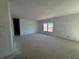 Large living room with two windows and an open floor plan at 2129 Boxwood Circle Se, Conyers, GA 30094