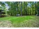 Large backyard with lush green grass and a storage shed at 3054 Chelsea Ln, Acworth, GA 30102