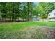 Large backyard with green grass and mature trees at 3054 Chelsea Ln, Acworth, GA 30102