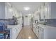 Bright kitchen with white cabinets, quartz counters and blue tile backsplash at 5217 Glenn Ct, Lilburn, GA 30047