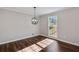 Bright dining room with hardwood floors and a modern chandelier at 388 Fieldstone Sw Ct, Lilburn, GA 30047