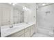 Bathroom boasts double sinks, marble tile, and a tub at 5760 Vista Brook Dr, Suwanee, GA 30024