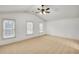 Spacious bedroom with vaulted ceiling, carpet, and multiple windows at 5760 Vista Brook Dr, Suwanee, GA 30024