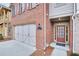 Front entry of townhome with brick facade and double doors at 5760 Vista Brook Dr, Suwanee, GA 30024