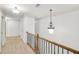 Upstairs hallway with carpet and modern light fixture at 5760 Vista Brook Dr, Suwanee, GA 30024