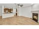 Living room with hardwood floors, kitchen island, and fireplace at 5760 Vista Brook Dr, Suwanee, GA 30024