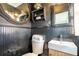 Bathroom features dark wood paneling and a pedestal sink at 1863 Derrill Dr, Decatur, GA 30032