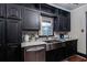 Modern kitchen with stainless steel appliances and dark cabinetry at 1863 Derrill Dr, Decatur, GA 30032