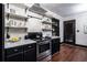 Kitchen with dark cabinetry, marble countertops, and floating shelves at 1863 Derrill Dr, Decatur, GA 30032